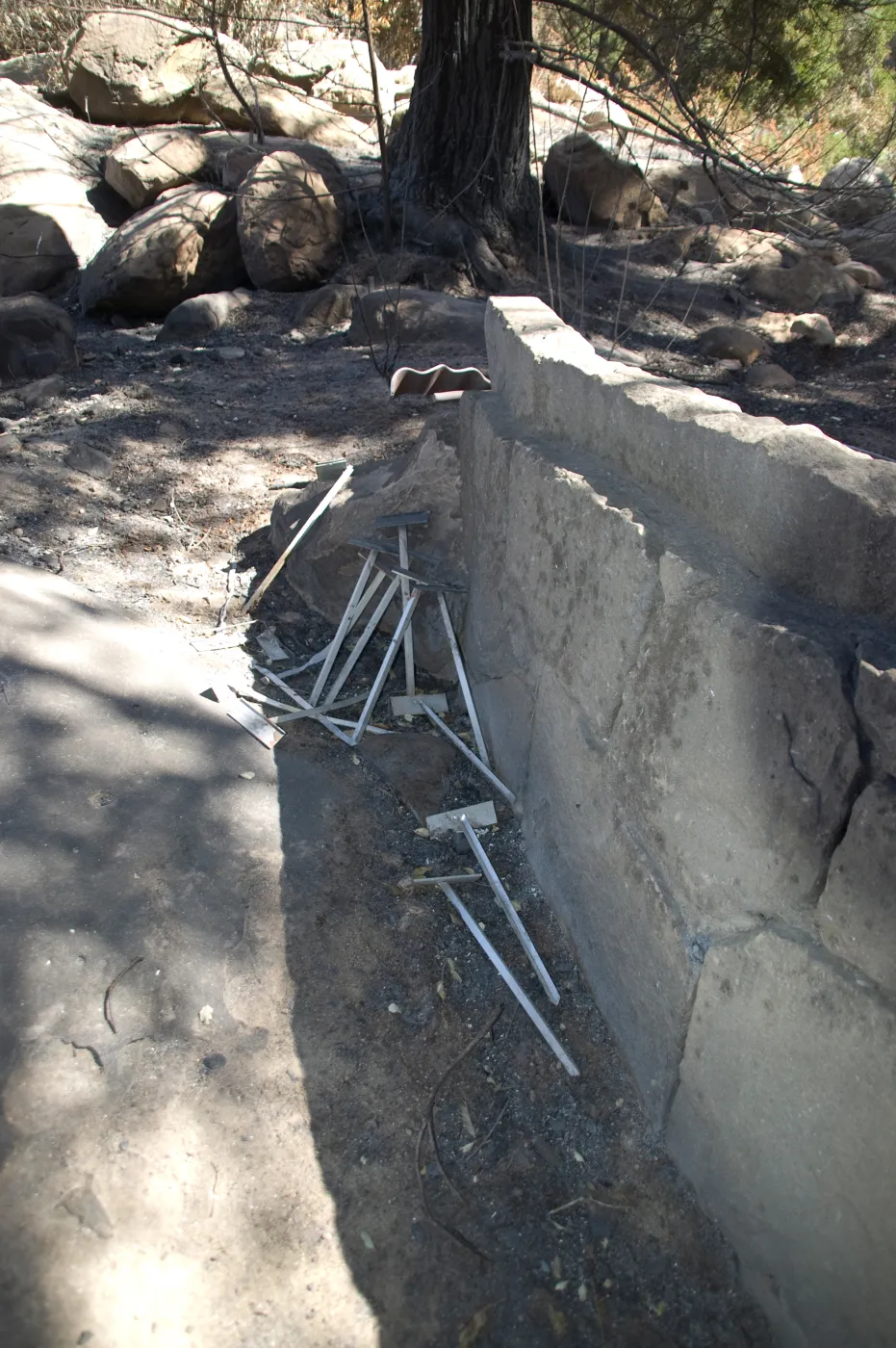 Santa Barbara Botanic Garden after the Jesusita Fire, plant stakes behind stone bench