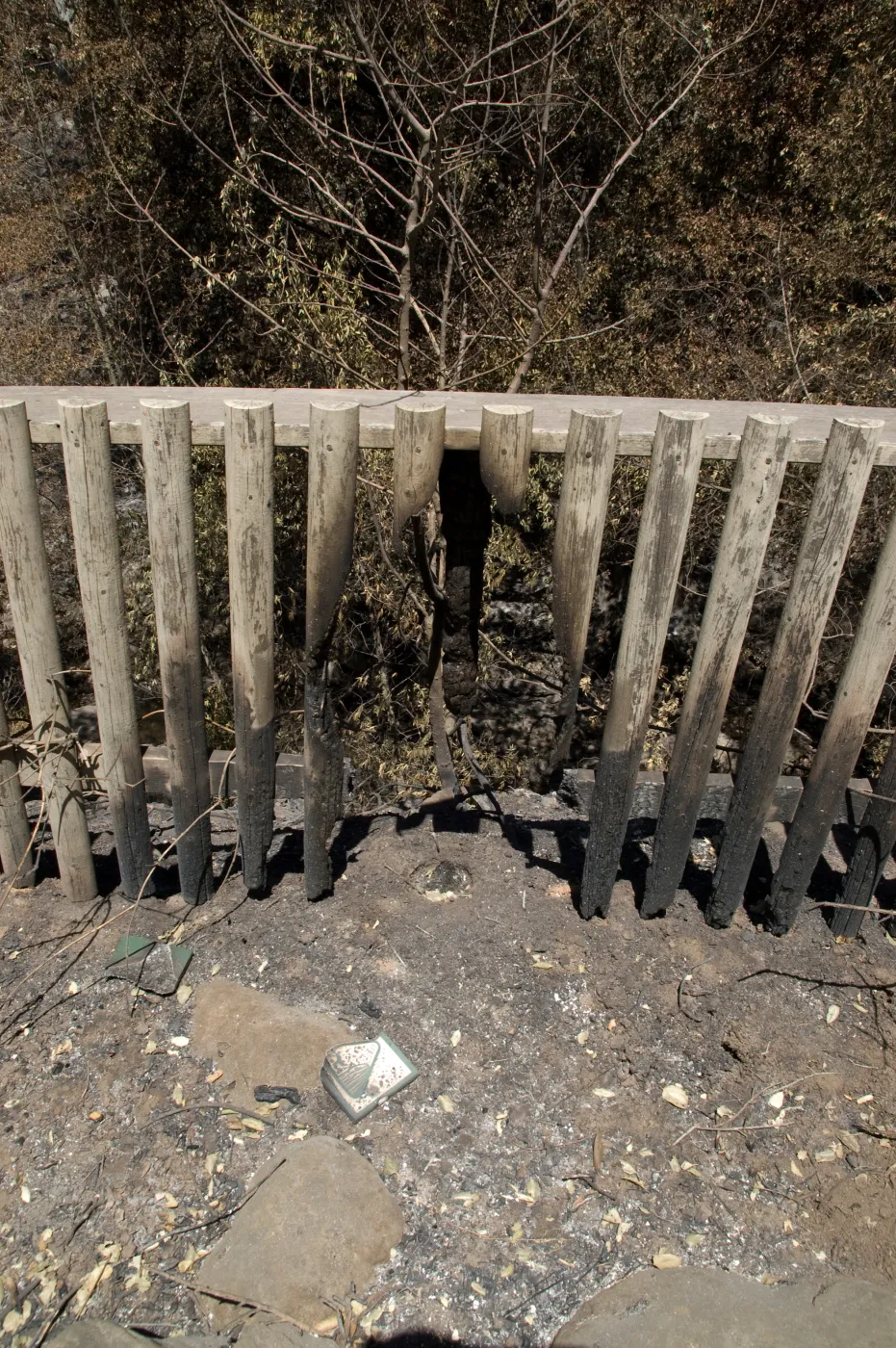 burned fence railing and sign after the Jesusita Fire