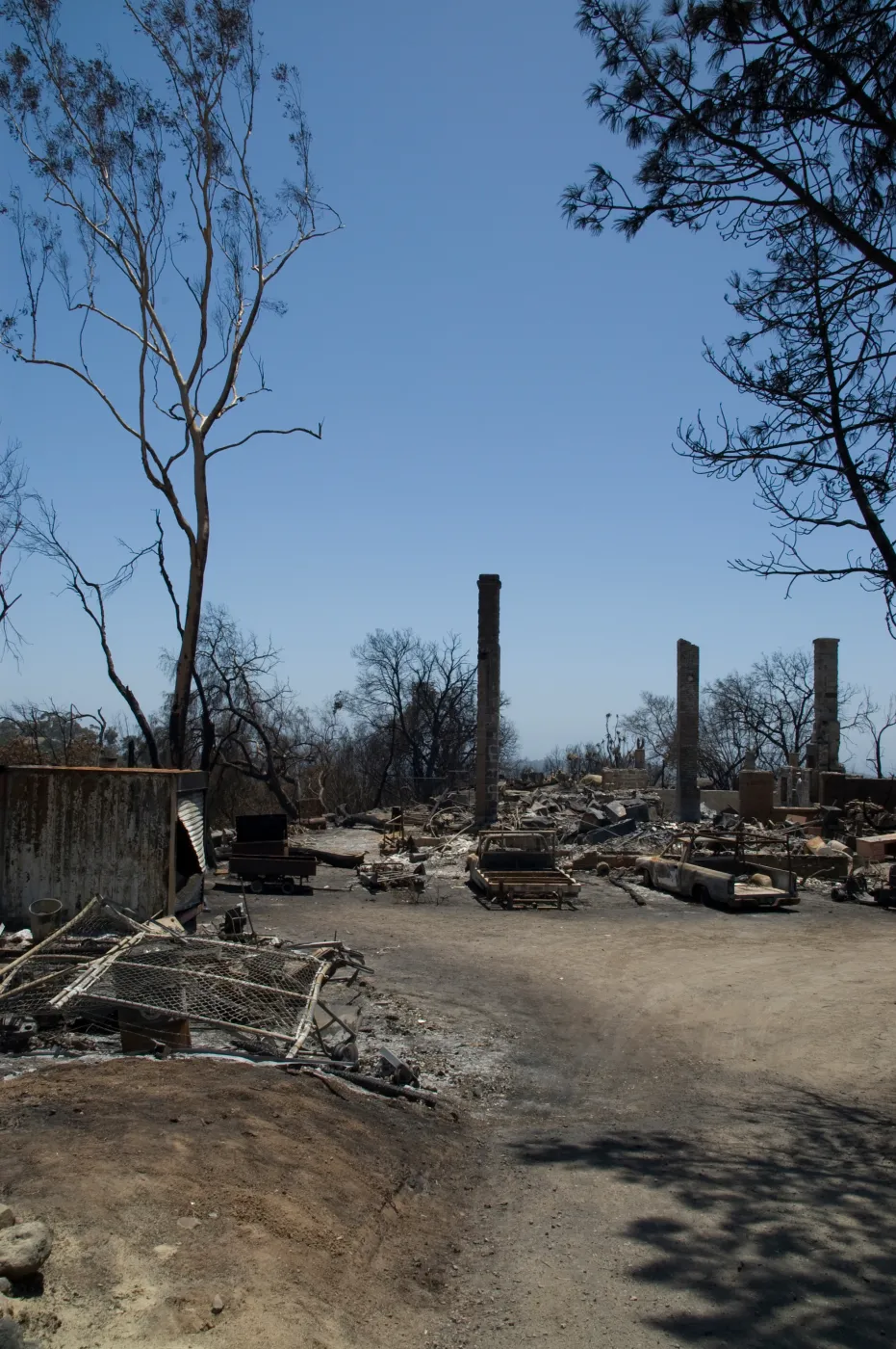 burned vehicles parked outside the Gane House, after the Jesusita Fire