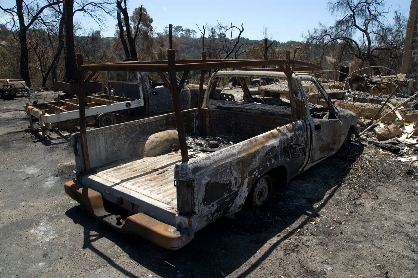 burned trucks in front of Gane House after the Jesusita Fire