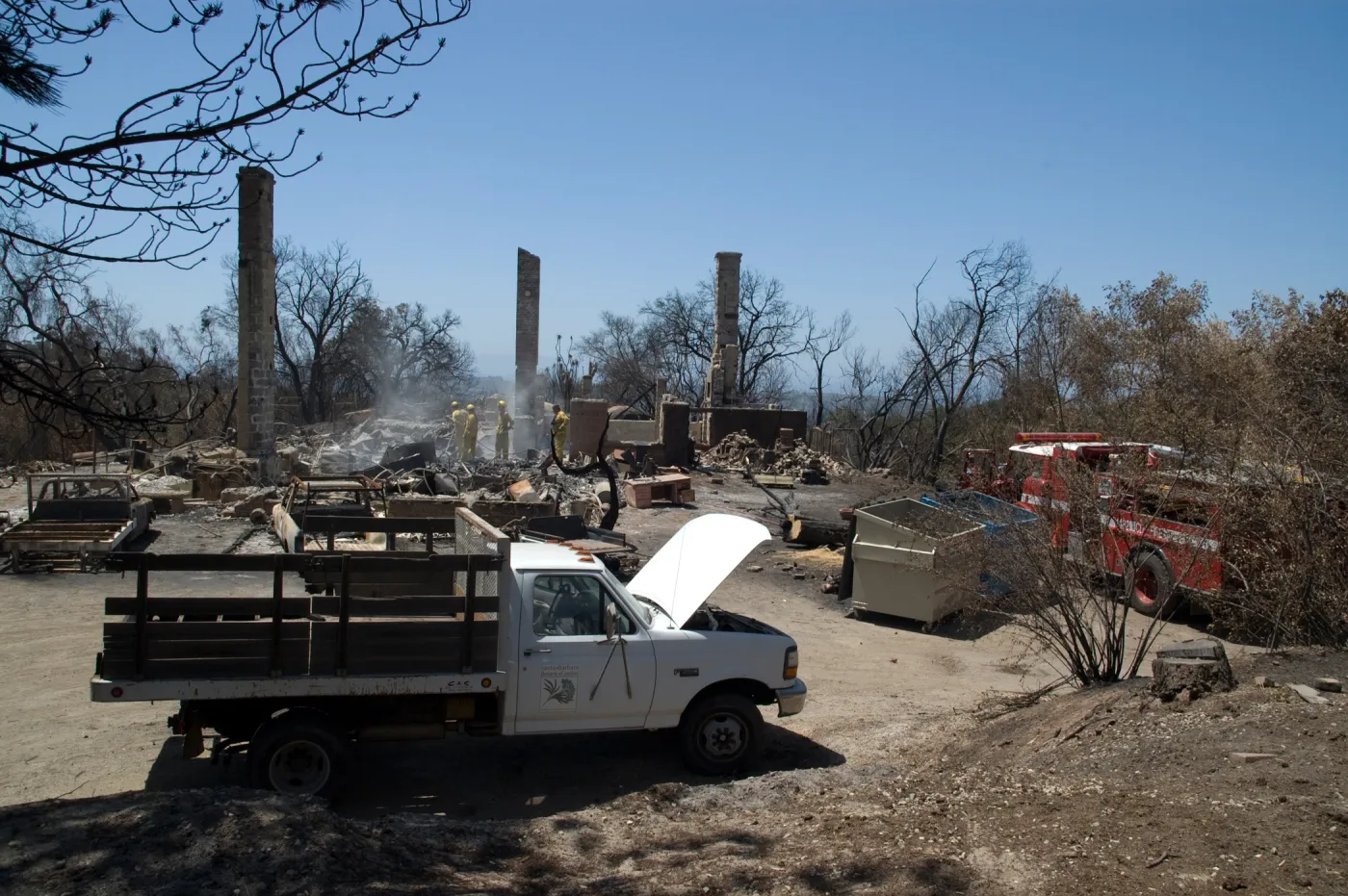 firefighters and firetruck at the Gane House site, after the Jesusita Fire