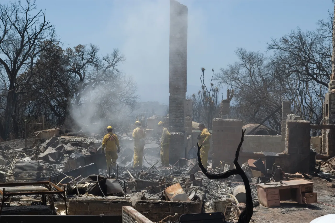 firefighters put out a hot spot at the Gane House site, after the Jesusita Fire