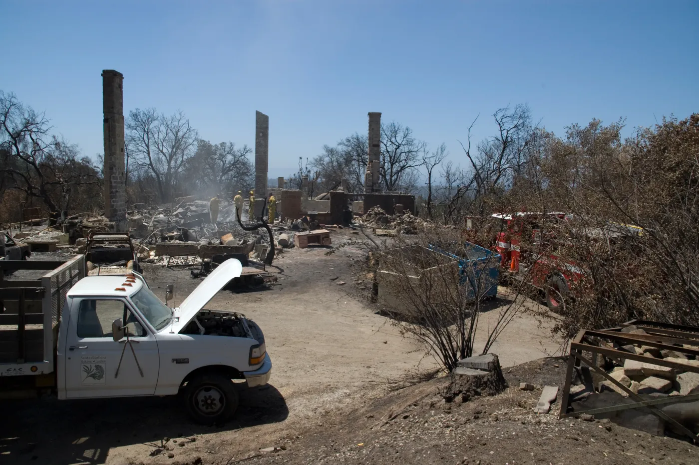 firefighters put out a hot spot at the Gane House site, after the Jesusita Fire