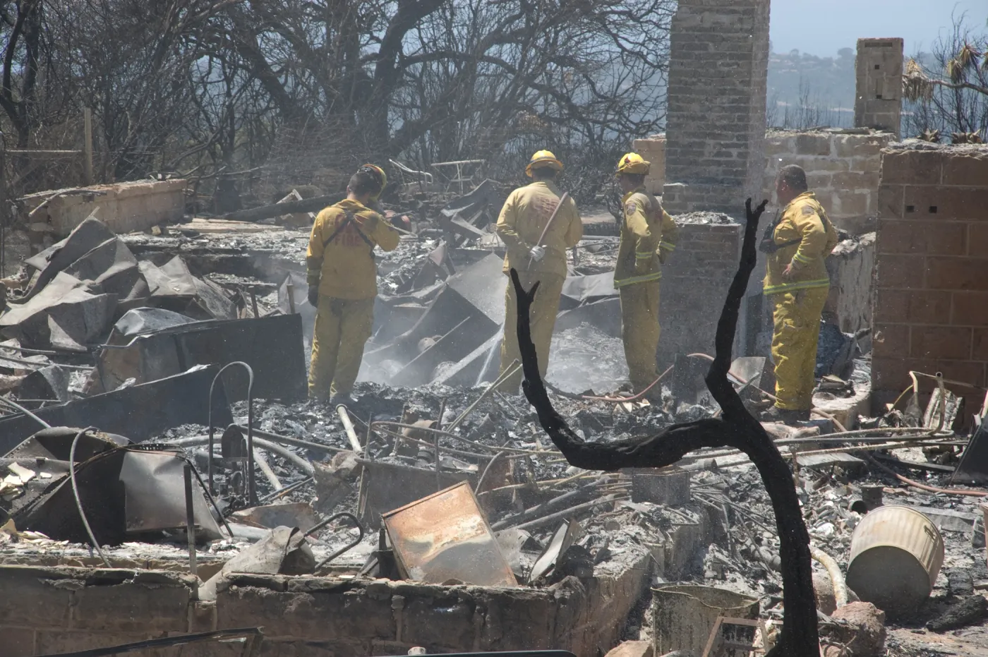 Firefighters put out a hot spot at the Gane House site, after the Jesusita Fire