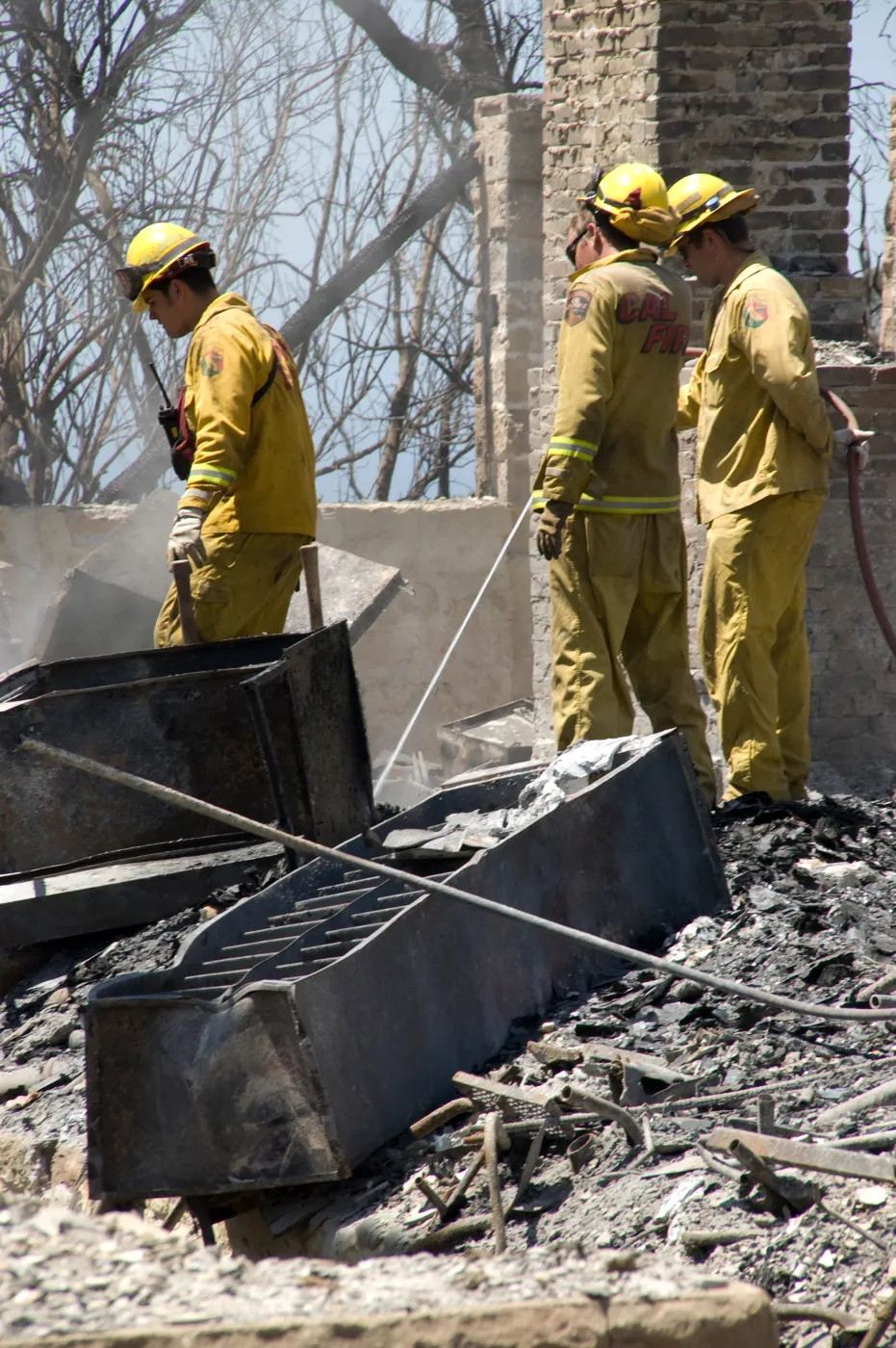 Firefighters put out a hot spot at the Gane House site, after the Jesusita Fire