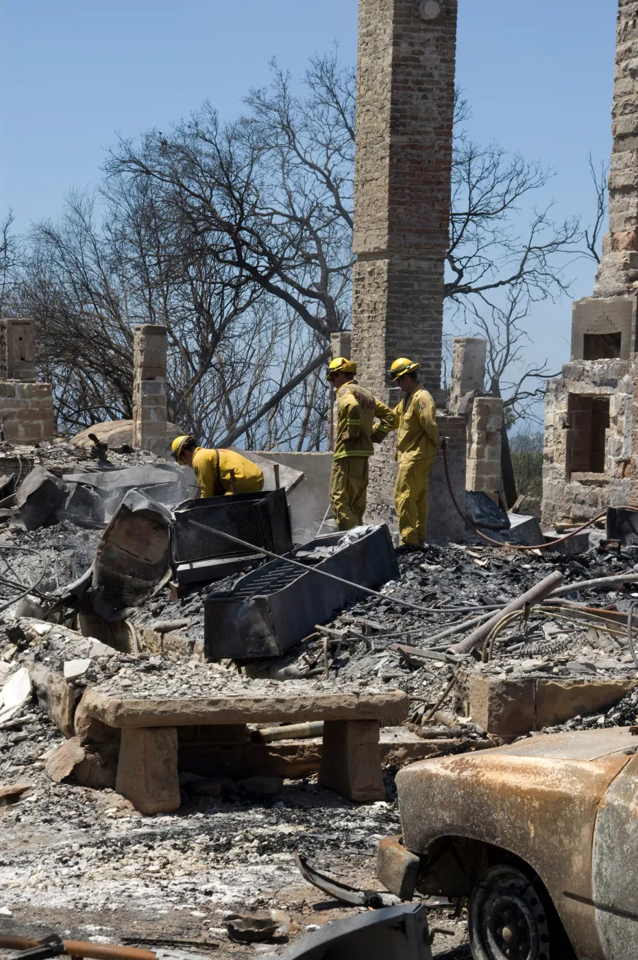 Firefighters put out a hot spot at the Gane House site, after the Jesusita Fire