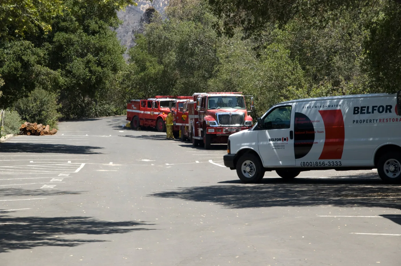 fire trucks and Balfor insurance van in the parking lot, after the Jesusita Fire