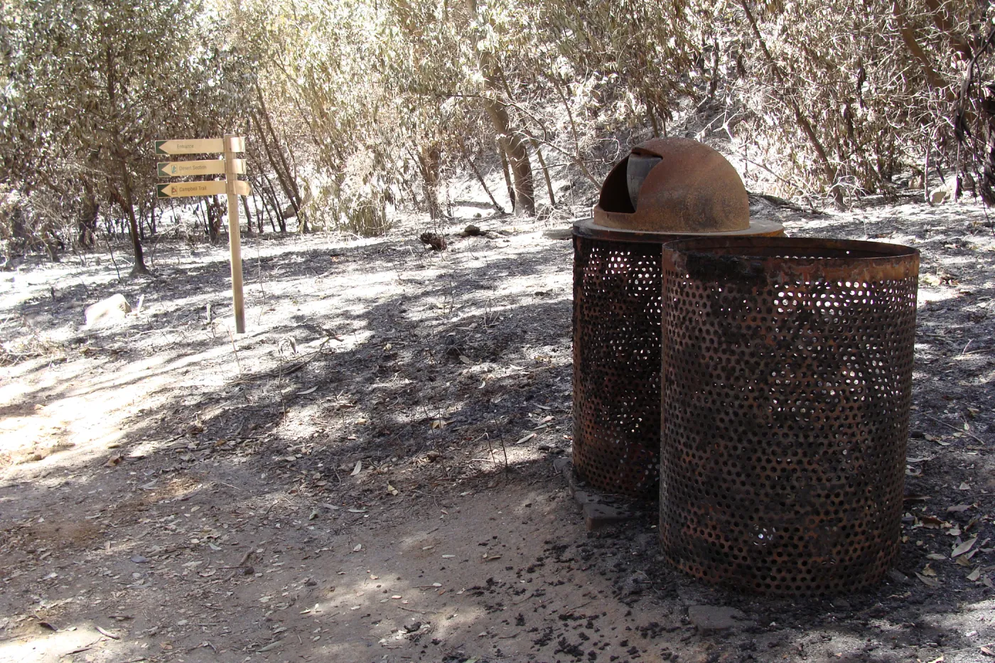 burned trash cans and directional signage along the Canyon Trail, after the Jesusita Fire