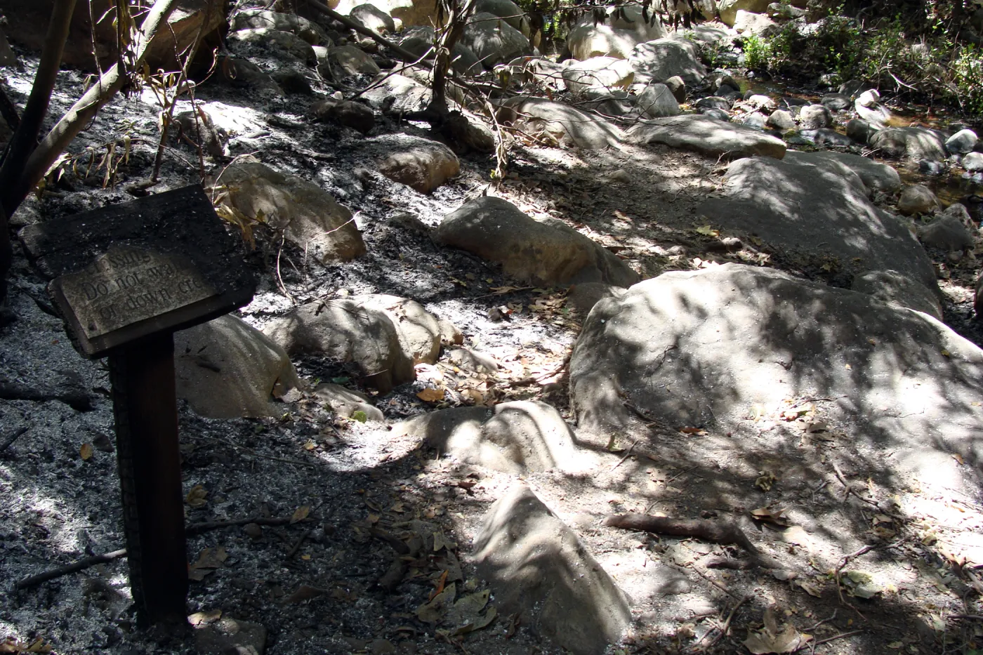 burned wood sign at the lower Mission Creek crossing point, after the Jesusita Fire