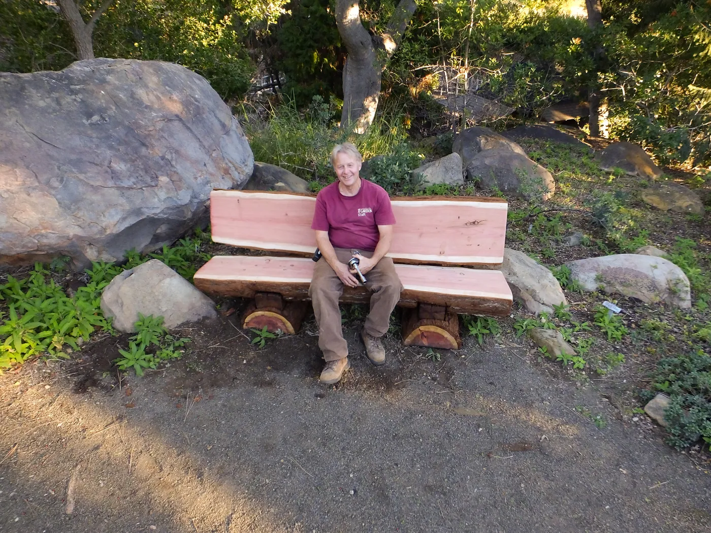 Dave Kershaw testing the newly installed Bobbie Jones bench, which he made from the giant sequoia removed from the Arroyo Section