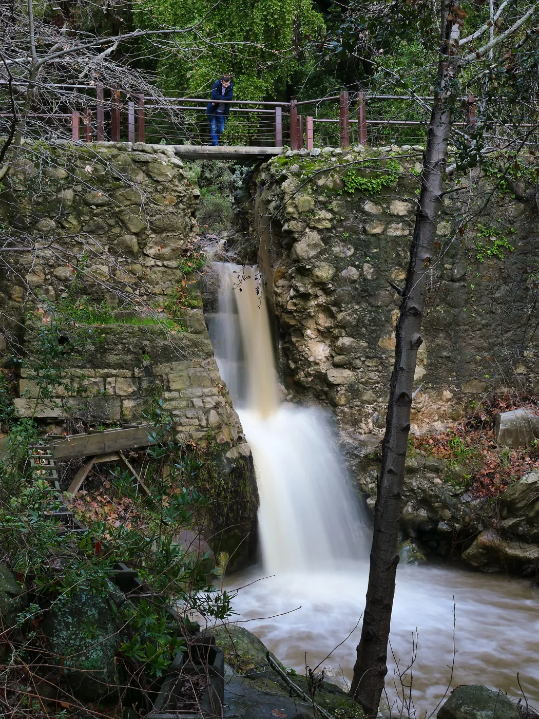 Visitor observing Mission Dam waterfall