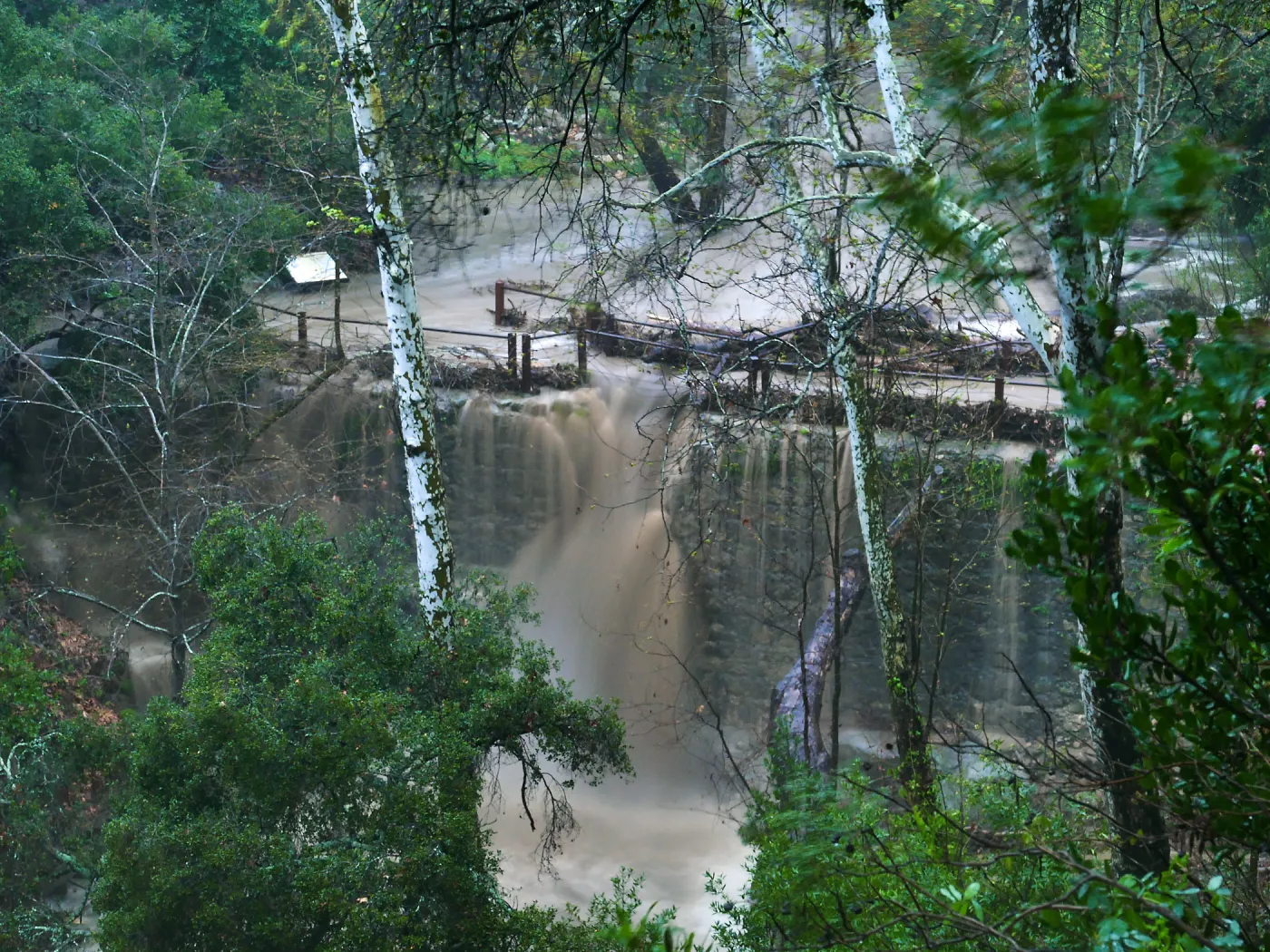 Mission Creek cresting Mission Dam during rainstorm
