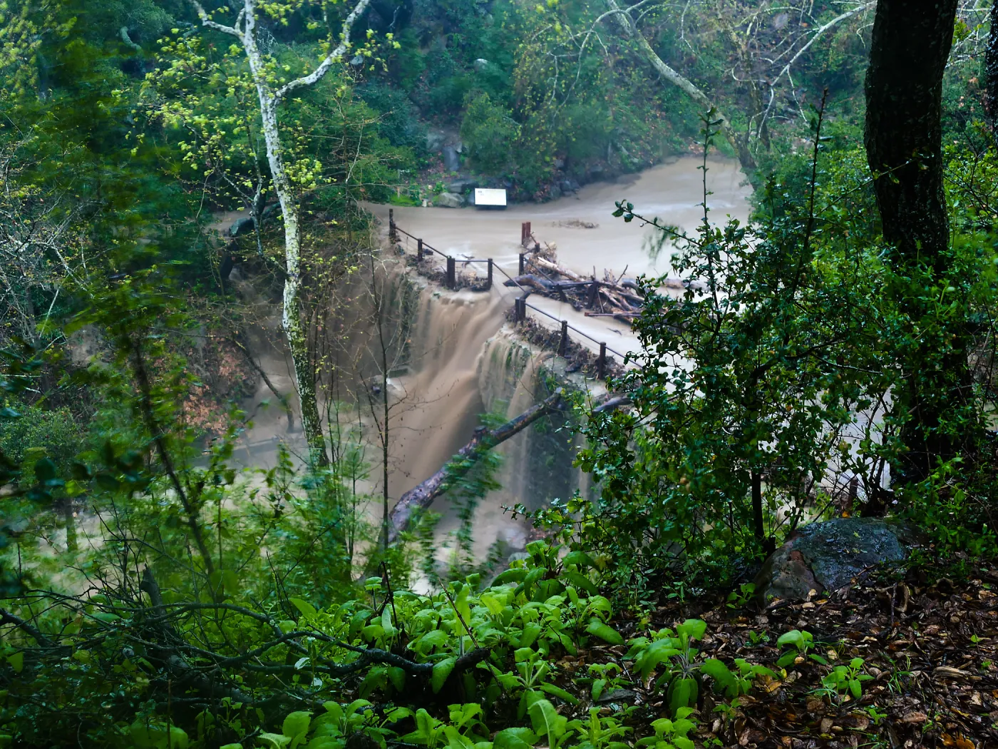 Mission Creek cresting Mission Dam during rainstorm