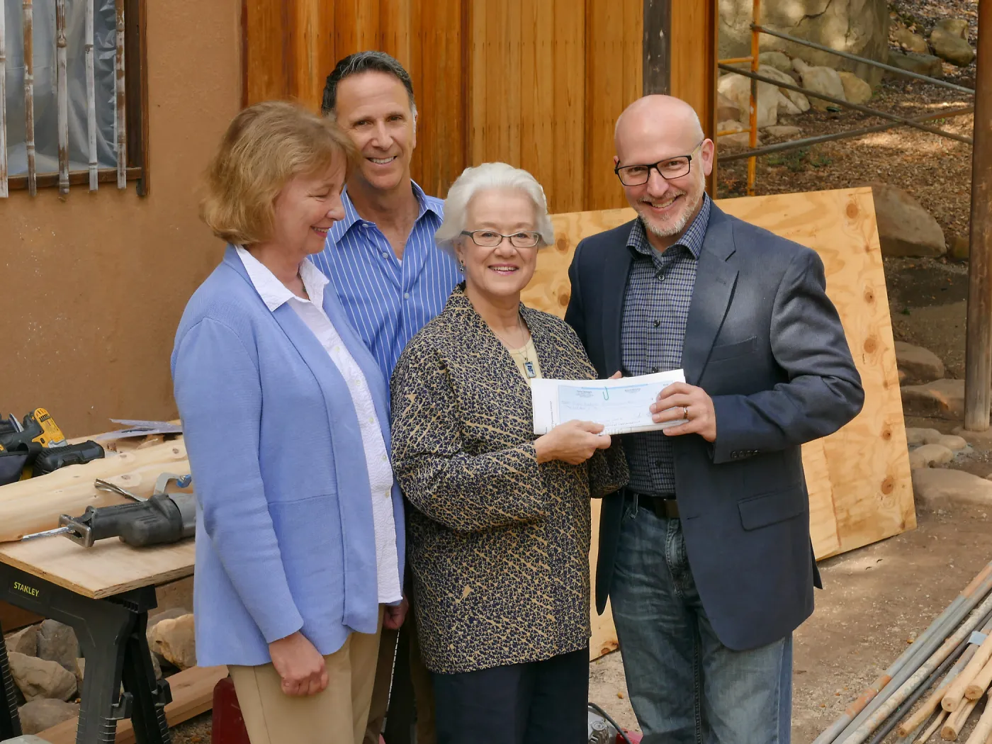 Linda Mathews, Chair of the Teahouse Improvements Fundraising Committee, gives Steve Windhager donations totaling $8,000 from the tea house volunteers to launch the fundraising for the repairs and improvements of the Teahouse and Tea Garden in 2017-2018