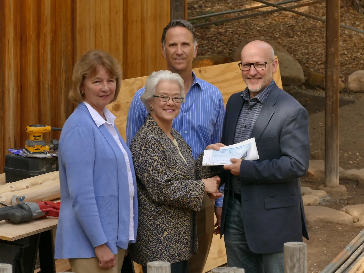 Linda Mathews, Chair of the Teahouse Improvements Fundraising Committee, gives Steve Windhager donations totaling $8,000 from the tea house volunteers to launch the fundraising for the repairs and improvements of the Teahouse and Tea Garden in 2017-2018