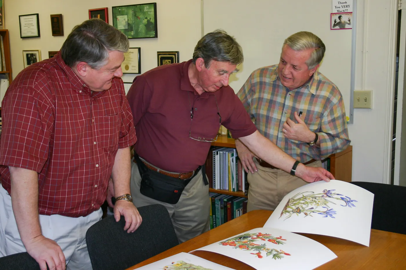 Ed Schneider, Patrick O'Hara, and Bob Sherwood viewing artwork