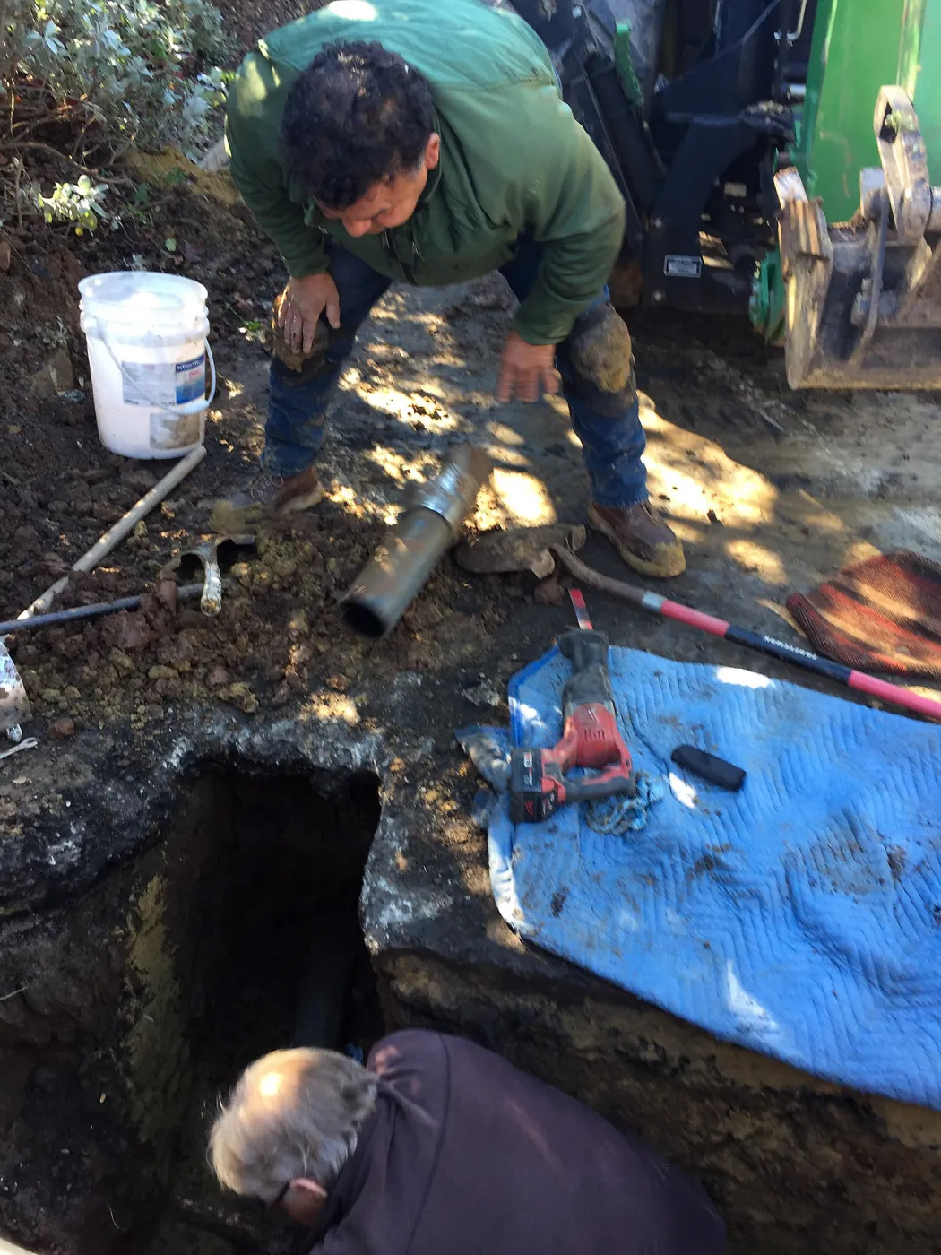 Jim Lechuga and Dave Kershaw working on irrigation water line repair in main parking lot, just south of the bike rack
