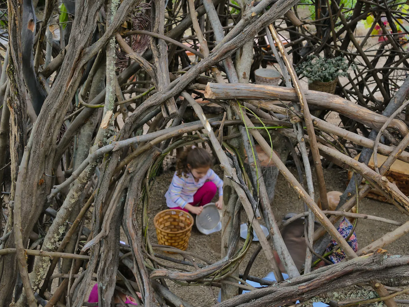 Santa Barbara Botanic Garden Casitas Opening, child playing in the â€œWoodrat Houseâ€ Casita