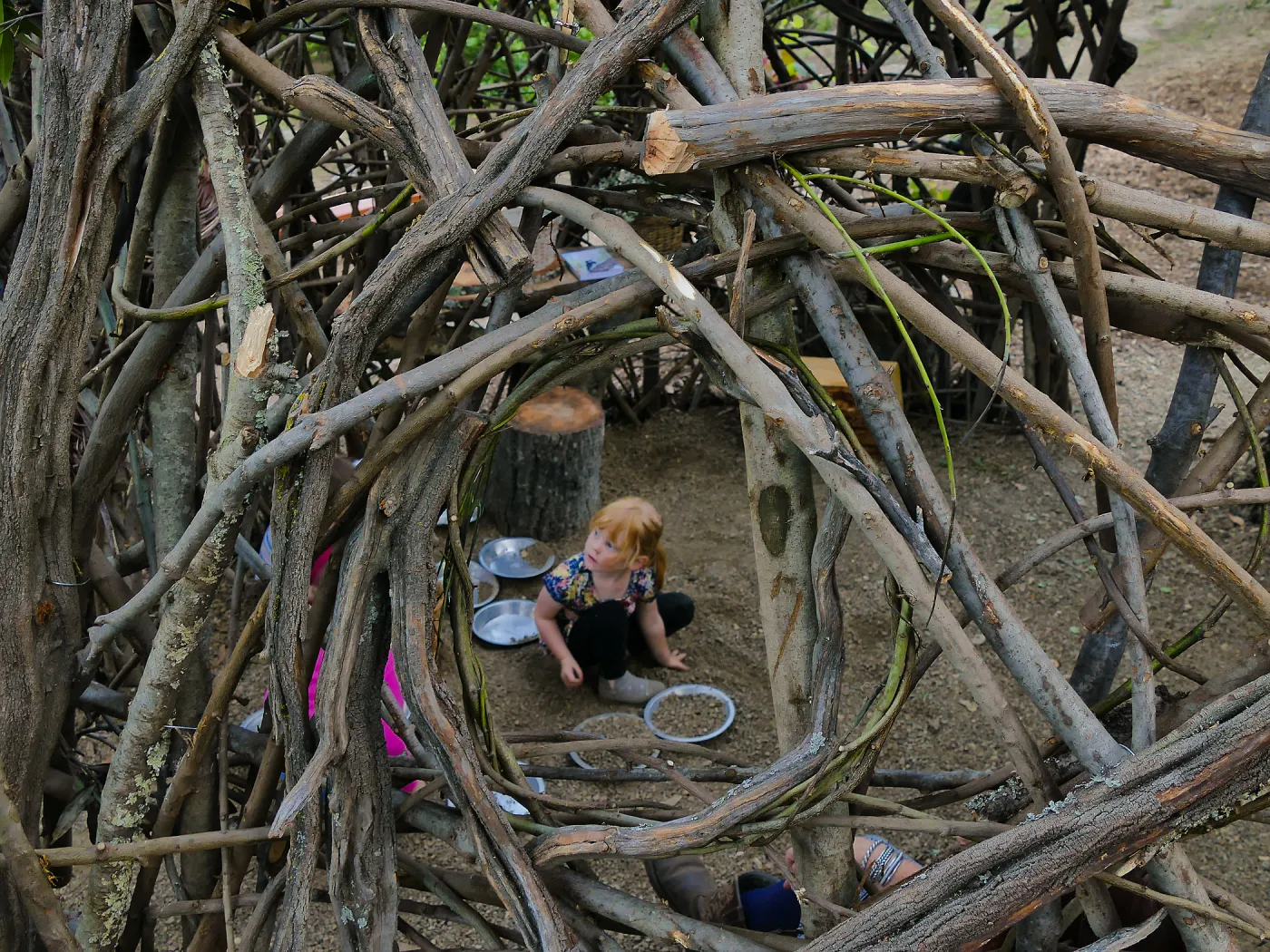 Santa Barbara Botanic Garden Casitas Opening, child playing in the â€œWoodrat Houseâ€ Casita