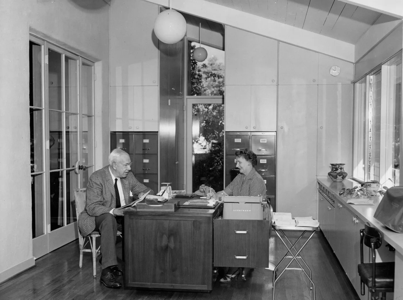 The first letter in the new office is dictated by Mr. Bullard to Miss Frances Hannah, office secretary.