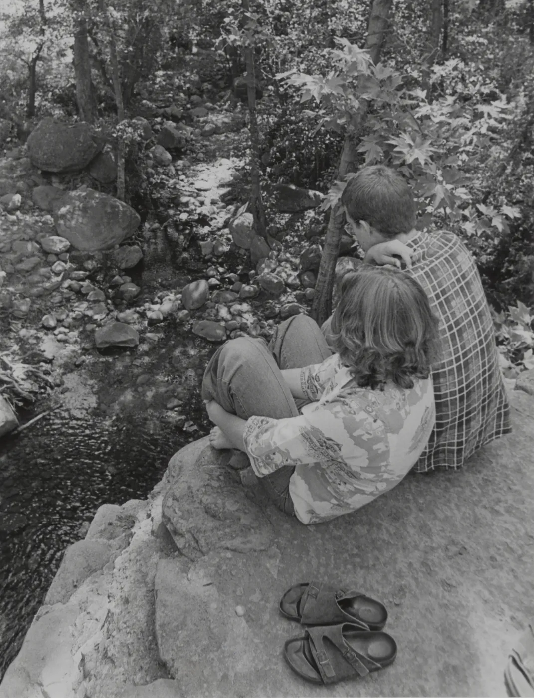 visitor couple sitting on top of old Mission Dam