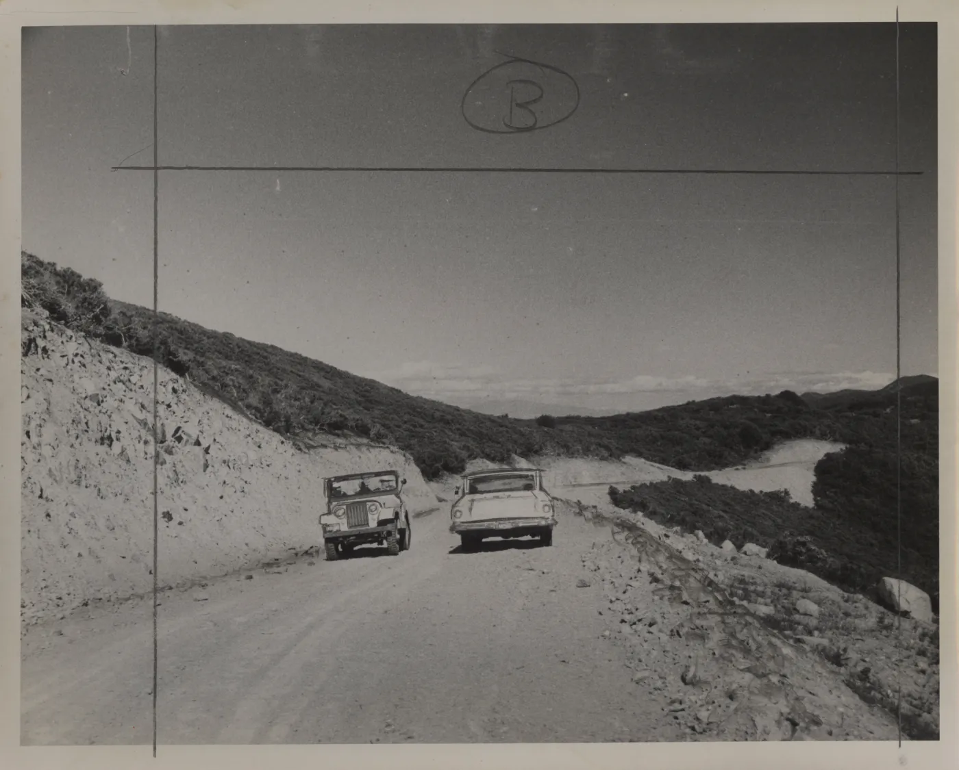 jeep and car on Sierra Madre Road, soon after construction