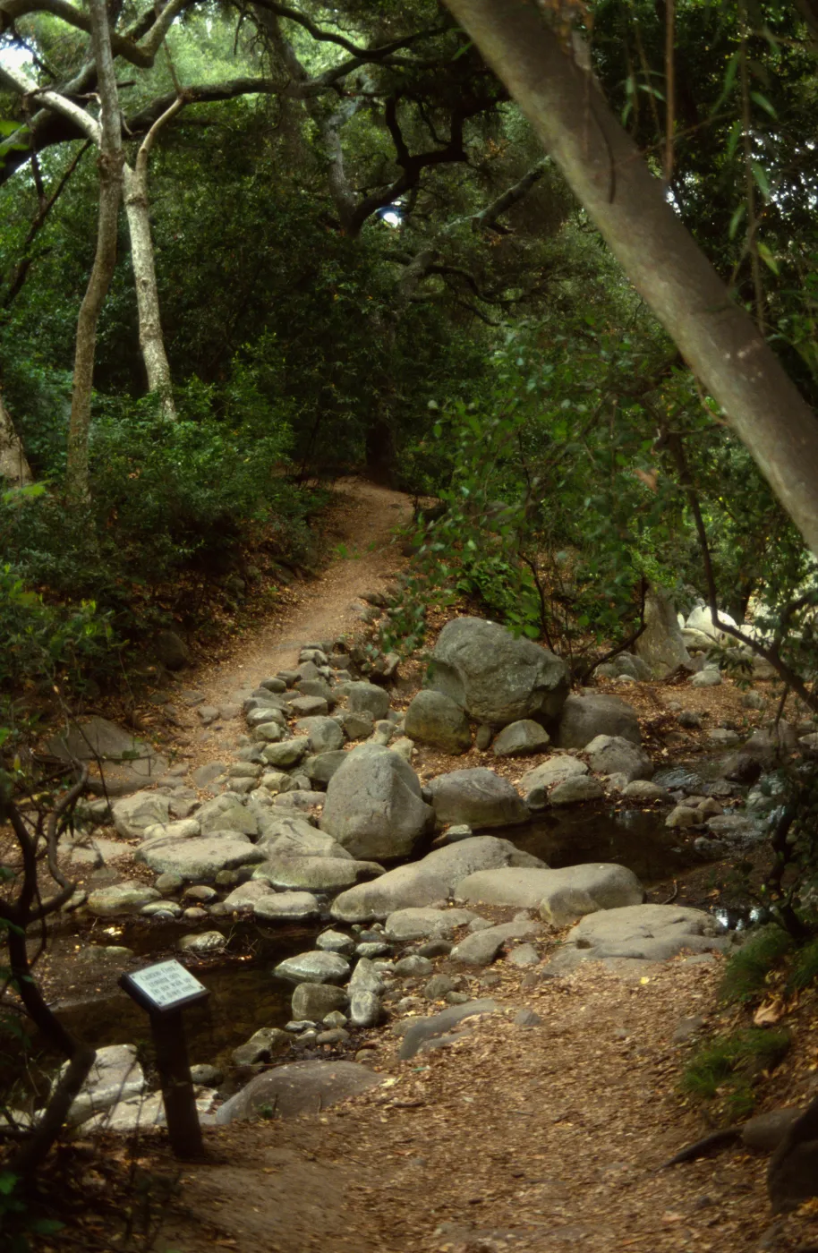 Path leading up to and leaving Mission Creek crossing with sign