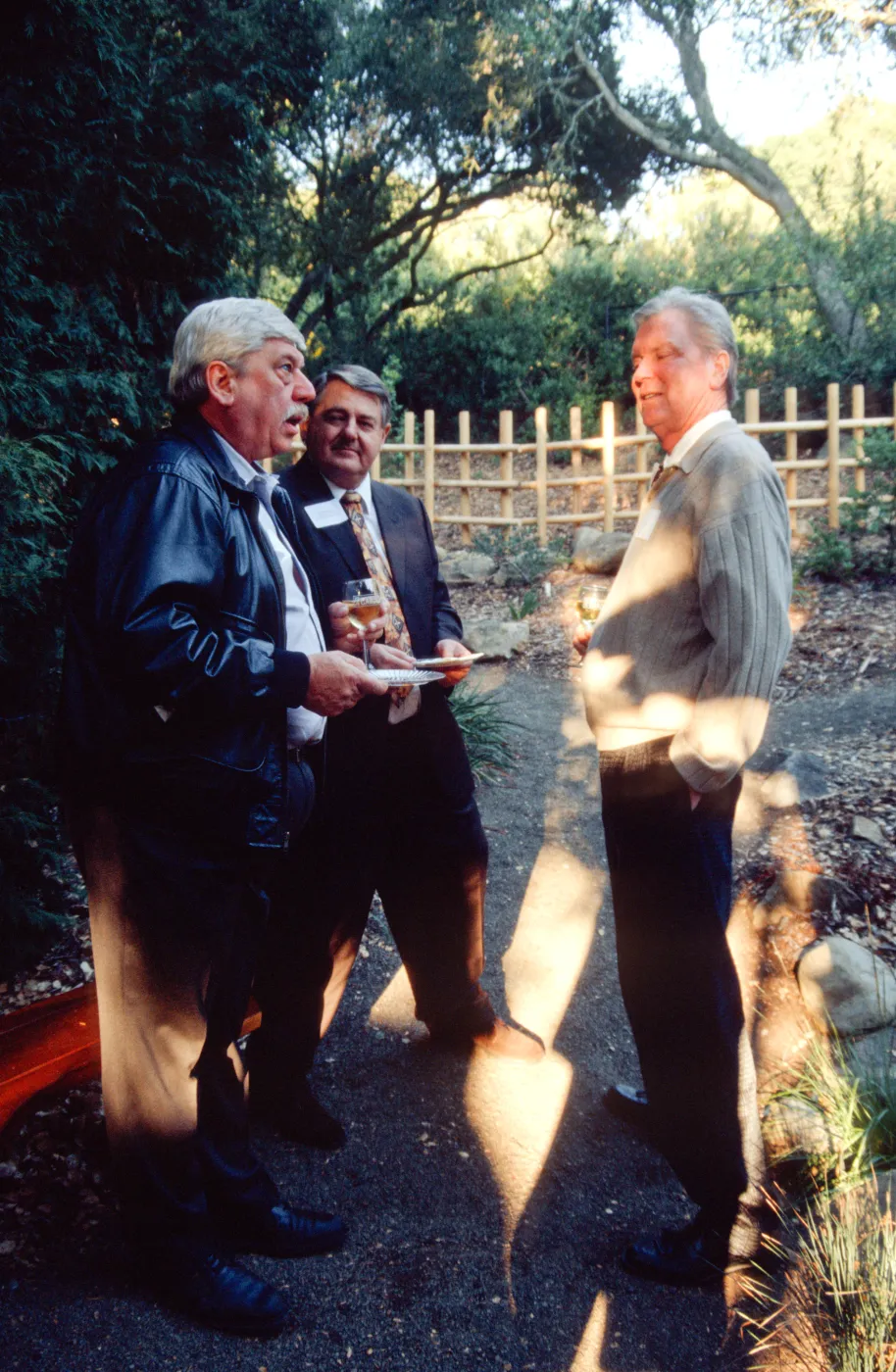 Ed Schneider with guests at tea house event