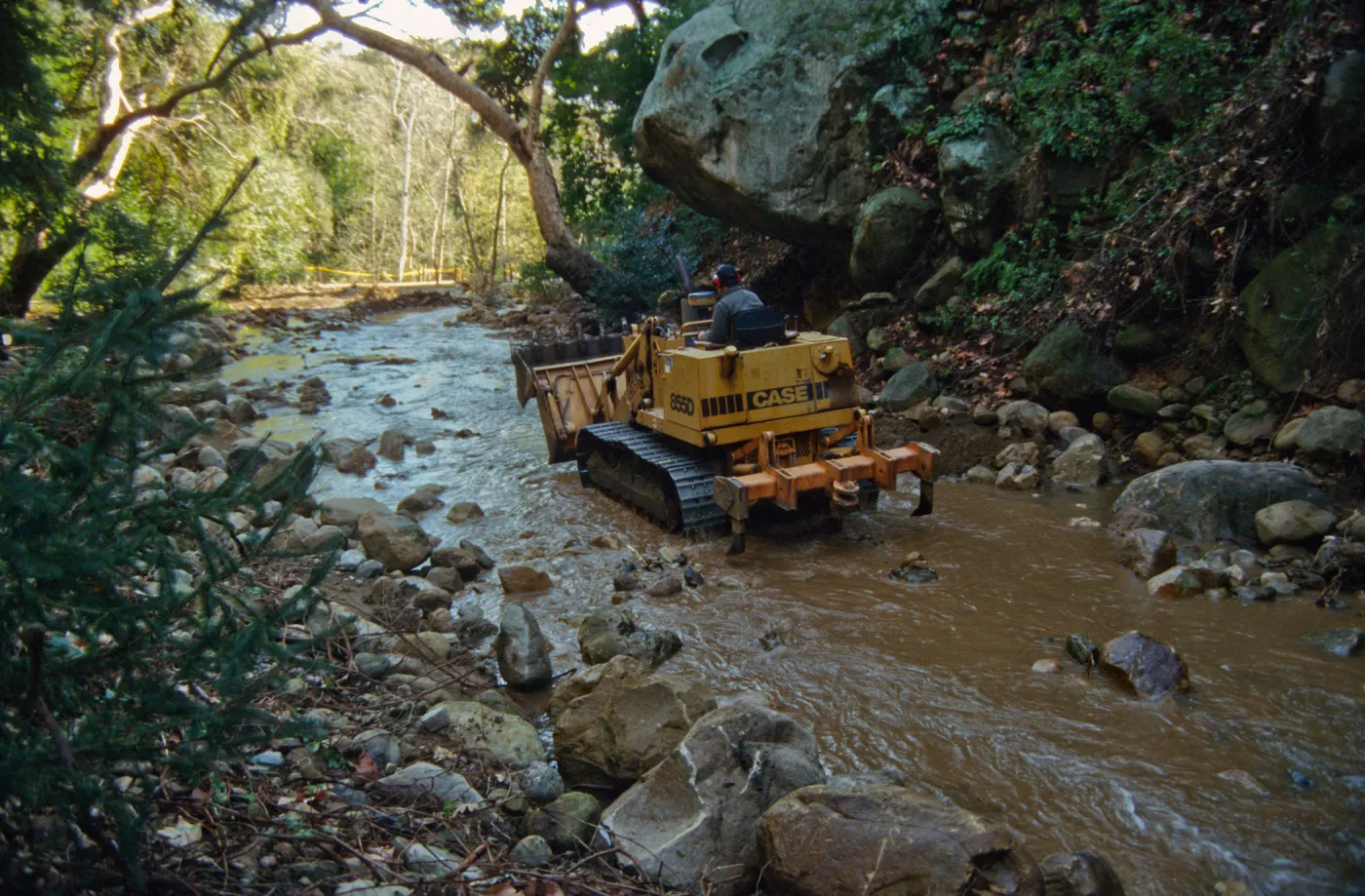 using a tractor to clear Mission Creek, above Mission Dam