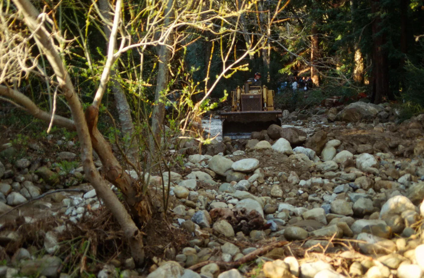 Mission Creek flooded above Mission Dam, with a bulldozer in background