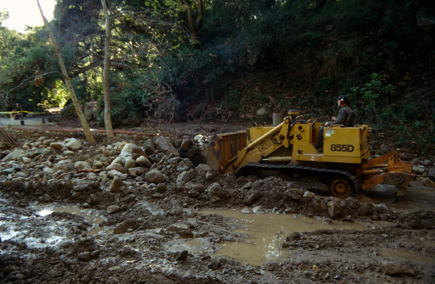 Mission Creek flooded above Mission Dam, with a bulldozer