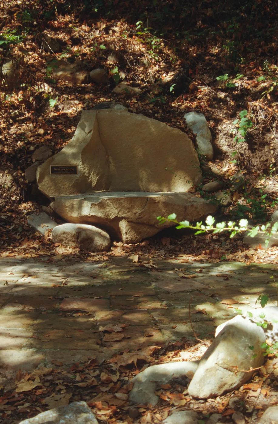 new stone bench with plaque, on west side of Mission Dam, exposed tiles