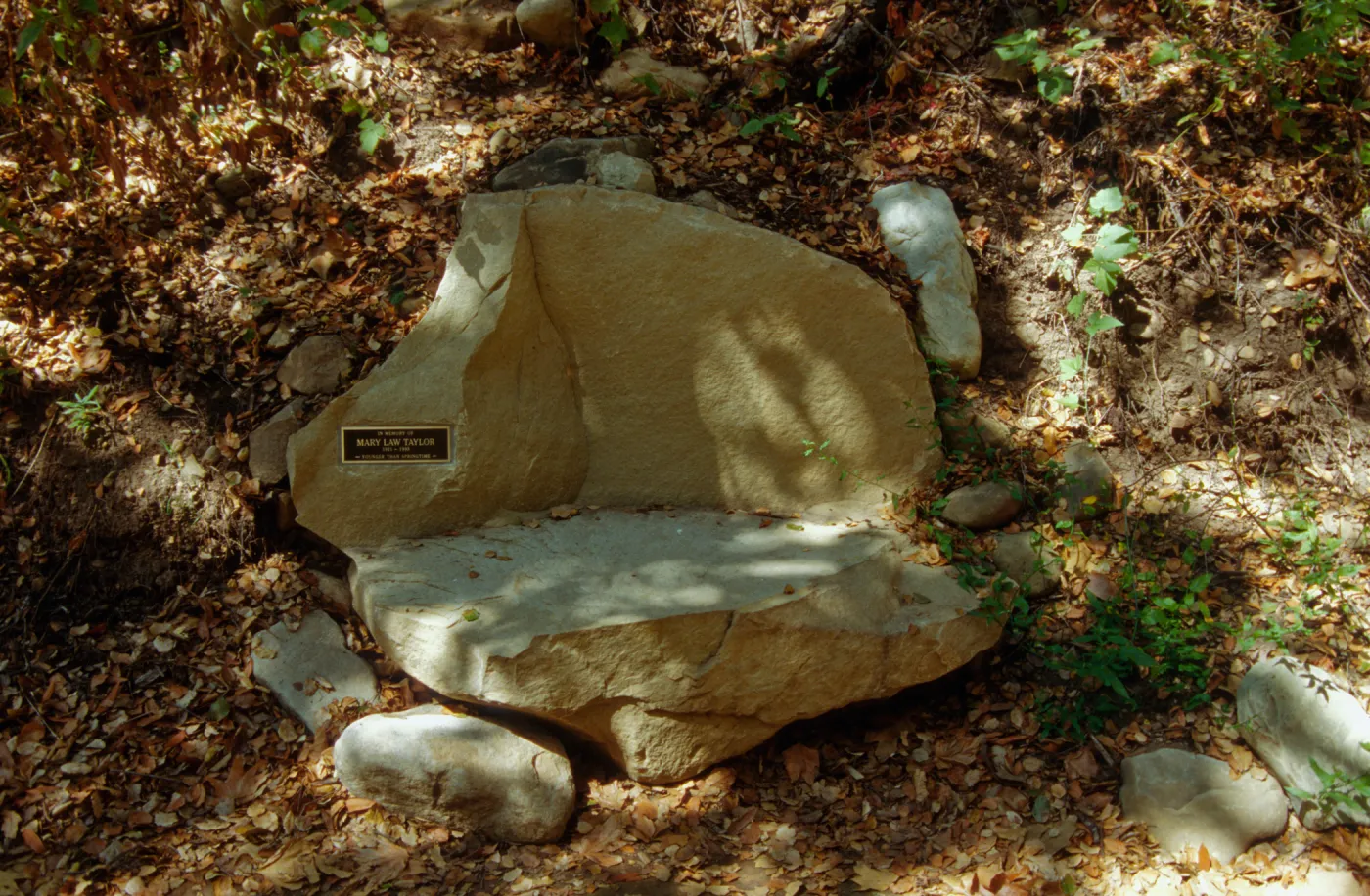 new stone bench with plaque, on west side of Mission Dam, exposed tiles