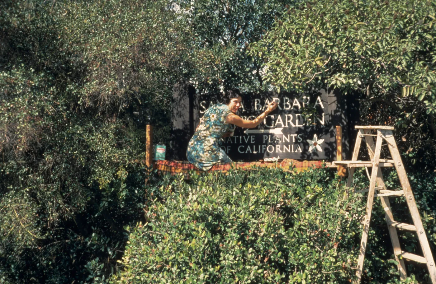 Jacqueline Broughton painting the entrance sign