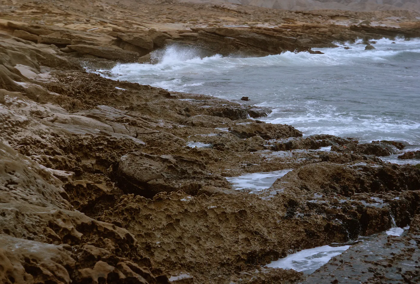 12/ looking East, rocky coast, 1.5 miles Northwest of Dutch Harbor, 65-160 & SN-77