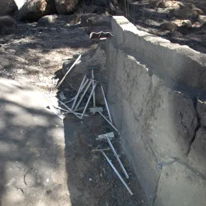 Santa Barbara Botanic Garden after the Jesusita Fire, plant stakes behind stone bench