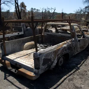 burned trucks in front of Gane House after the Jesusita Fire