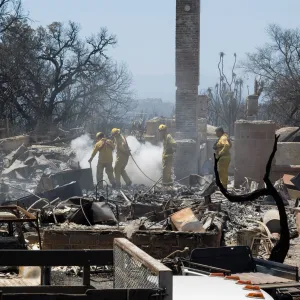 Firefighters put out a hot spot at the Gane House site, after the Jesusita Fire