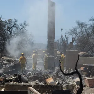 firefighters put out a hot spot at the Gane House site, after the Jesusita Fire