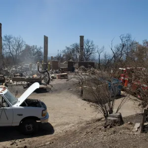 firefighters put out a hot spot at the Gane House site, after the Jesusita Fire