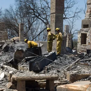 Firefighters put out a hot spot at the Gane House site, after the Jesusita Fire