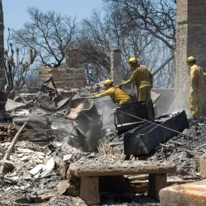 Firefighters put out a hot spot at the Gane House site, after the Jesusita Fire