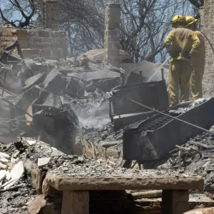 Firefighters put out a hot spot at the Gane House site, after the Jesusita Fire