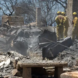 Firefighters put out a hot spot at the Gane House site, after the Jesusita Fire