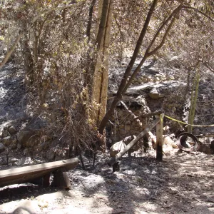 burned wood bench and remains of the Campbell Bridge, after the Jesusita Fire