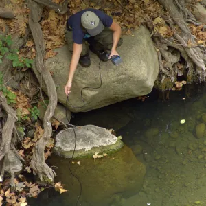Steelhead trout release below Mission Dam. Gaytha Morningstar checks water temperature and oxygen content.
