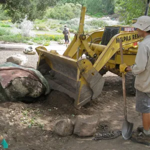 Moving boulders for bed on north side of Meadow Oaks