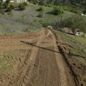 Road grading at Cavelli property to control soil erosion into neighboring property