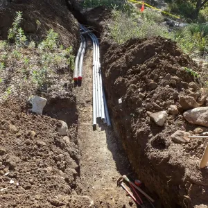 Power and data conduit being installed in the Arroyo Section