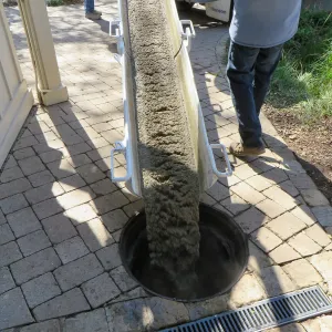 Filling septic tank at entrance with cement slurry